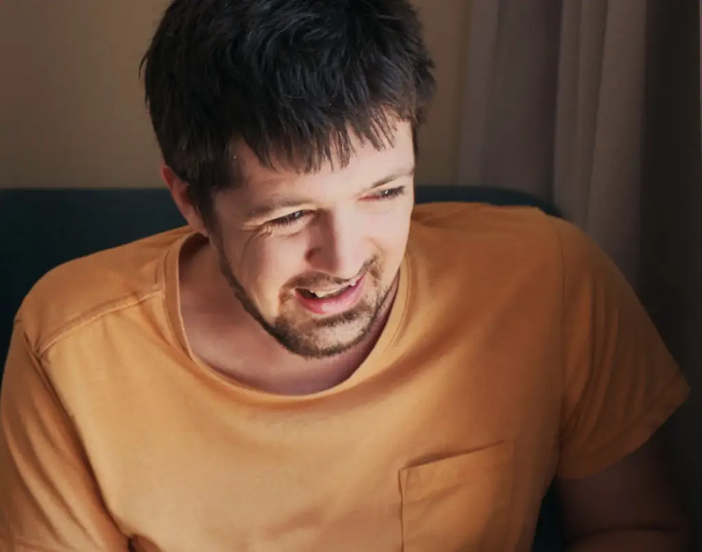 Man smiling off to the side